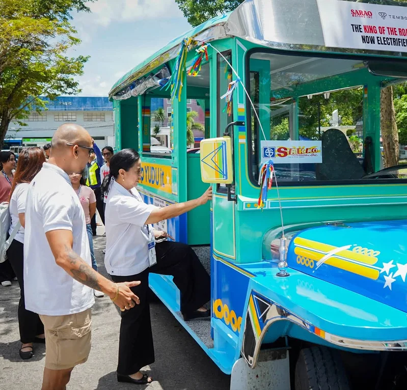 Officials boarding an electric jeepney at the launch