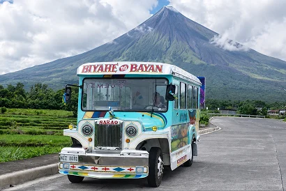 Electric jeepney in front of Mayon Volcano, Albay